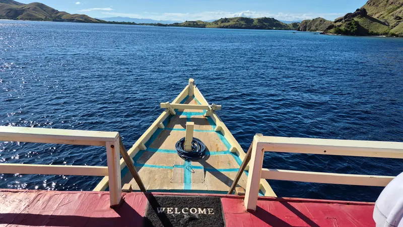 Bow of the Mai Explore daily dive boat heading out across Komodo waters