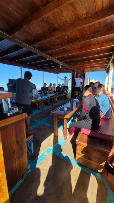 Shaded dive deck with gear stations on the boat