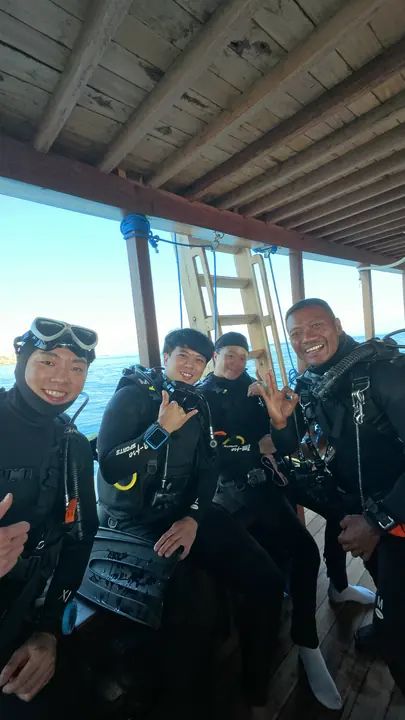 Mai Explore dive team smiling on the dive boat